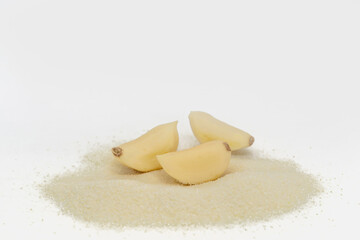 Garlic and garlic powder on white background