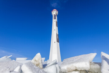 Modern lighthouse at winter in The Gulf of Finland, Saint-Petersburg, Russia, blue sky and ice