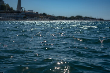 Sun glare on the water surface in the background view of the city.