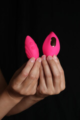 Woman holding her brand new Pink remote controlled silicon vibrator.