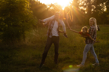 Happy family on sunset in nature
