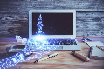 Desktop computer background in office and start up theme hologram drawing. Double exposure. Startup concept.