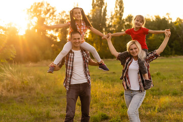 Fototapeta premium Happy family on sunset in nature