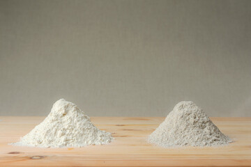 Fototapeta na wymiar Rye flour and wheat flour on linen background