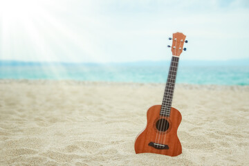 Fototapeta na wymiar beautiful guitar on the sand by the Greek sea