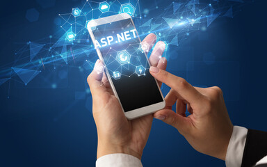 Female hand holding smartphone with ASP.NET inscription, modern technology concept