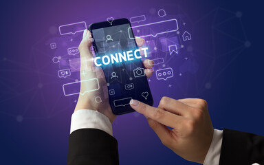 Female hand typing on smartphone with CONNECT inscription, social media concept