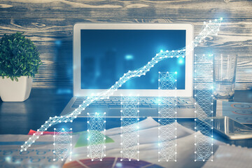 Double exposure of graph and financial info and work space with computer background. Concept of international online trading.