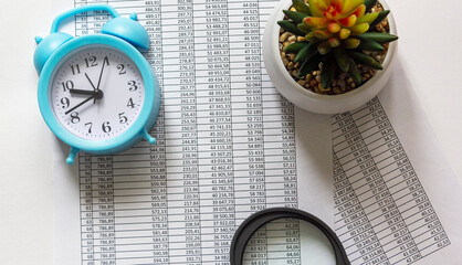 Alarm clock, cactus flower, magnifier on the graphics background