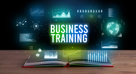 BUSINESS TRAINING inscription coming out from an open book, creative business concept