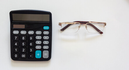 Project inscription of text on a calculator and glasses on a white background. Plan of creation, idea, option for the future, the possibility of its implementation.