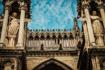View of the exterior facade of the Roman Catholic Notre Dame de Reims Cathedral, a historical...