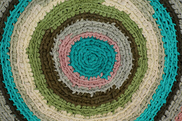 Colorful knitted carpet form used shirts, recycle concept