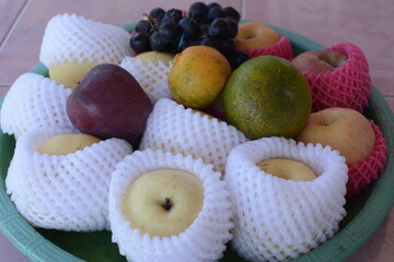 a pile of fresh fruit on a tray