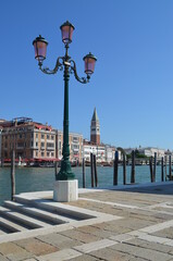 

San Marco bell tower in Venice with lamp post in the foreground