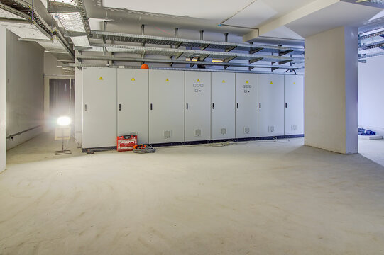 control cabinet in control room. Mechanic's maintenance room concept. Green, yellow, red button on white cabinet. Electrical cabinet in room. Distribution board. panelboard, breaker panel
