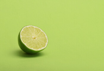 Lime slice on green background