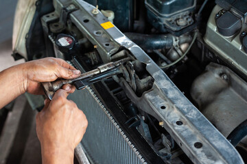 Hands of mechanic working in auto repair shop - 376037098