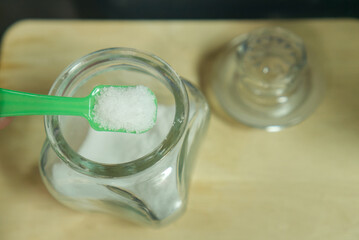 salt in the spoon on wooden background