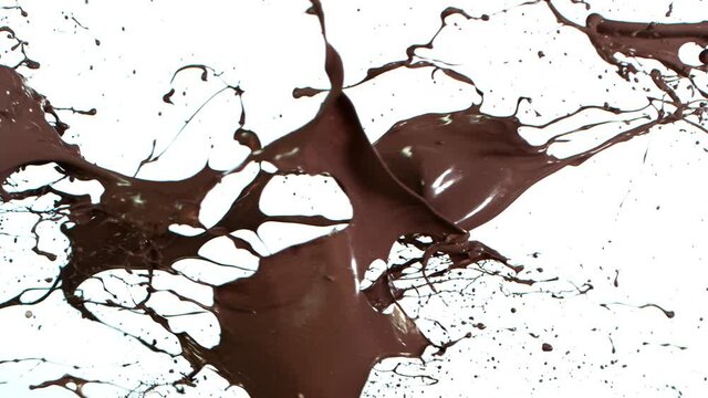 Super Slow Motion Shot of Milk and Chocolate Splash at 1000 fps Isolated on White Background.