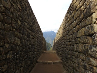 Inca Stone Wall corridor in Machu Picchu. Window to Peruvian Andes Mountains.