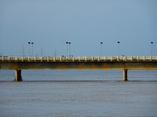 Fototapeta na wymiar Old bridge standing on river filled with water in Bhubaneswar