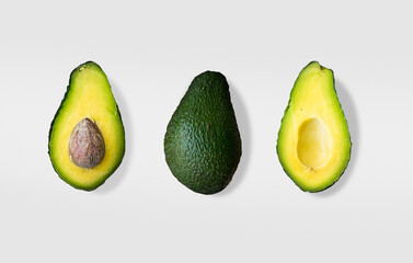Whole and cut avocado isolated on white background