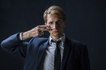businessman draws two stripes on his cheeks, war paint. Competition in business, concept.
