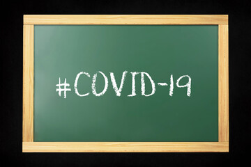 Obraz premium Coronavirus covid-19 hashtag made in chalk on chalkboard