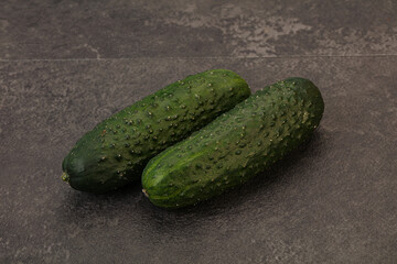 Green fresh cucumbers over background