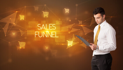 Businessman with shopping cart icons and SALES FUNNEL inscription, online shopping concept