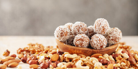 Sweet protein vegan balls in a bowl of various nuts. Homemade sugar free candy