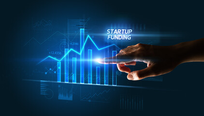 Hand touching STARTUP FUNDING button, business concept