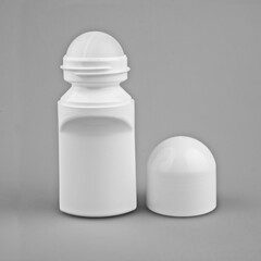 A bottle of deodorant on a gray background, makeup from the pot on an isolated background