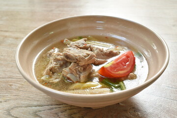 hot and spicy pork bone with mushroom in Thai tom yum soup on bowl 