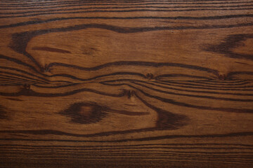 texture of dark red wood with knots covered with varnish