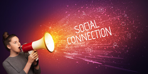 Young woman yelling to loudspeaker with SOCIAL CONNECTION inscription, social networking concept