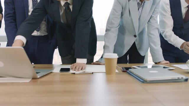 team of asian business people men and women meeting and working together in office