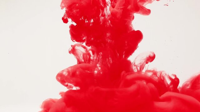 Abstract background of splashes of red paint in water, an explosion of red, splashes and spreading blood