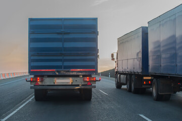 Trucks with trailers move along the highway