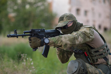 A professional airsoft player aims at his opponents