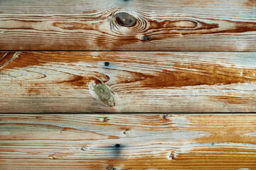 old weathered wooden planks as a brown background, peeling paint and cracks