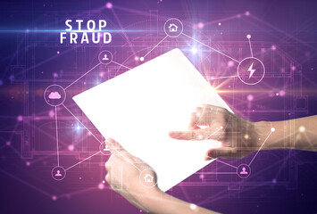 Holding futuristic tablet with STOP FRAUD inscription, cyber security concept
