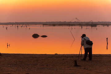 photographer shooting landscape in sunset