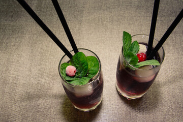 Purple Blues cocktail, lemonade with mint, blueberries, refreshing drink, on a gray background
