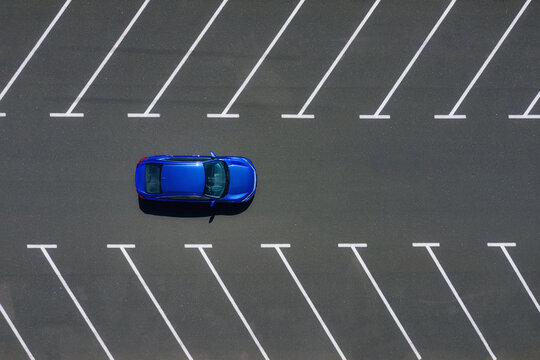 Transportation. View on the car from the air. Car in an empty parking lot. View of the vehicle from the drone. Travel by car.