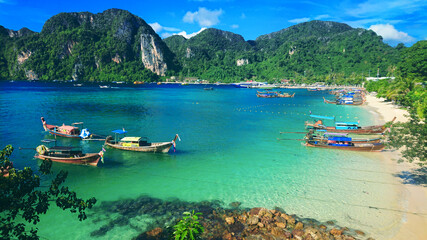 Beautiful view on the mountains and sea in the Phi Phi Don island near Phuket Island in Thailand. In the distance you can golden sand, azure water, thai boats and jungle in the mountains. © Project Space