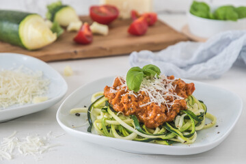 Zoodles bolognese: zucchini noodles with meat or vegan soy meat sauce and parmesan. For low carb,...