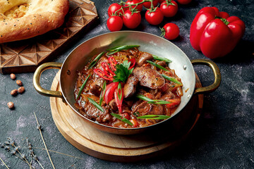 Azerbaijani roast liver, heart and navels in red sauce with onions. Eastern dish jyz-byz