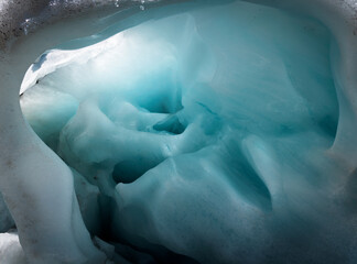Blue ice inside a mountain glacier grotto. Alibek, Dombay August 2020.